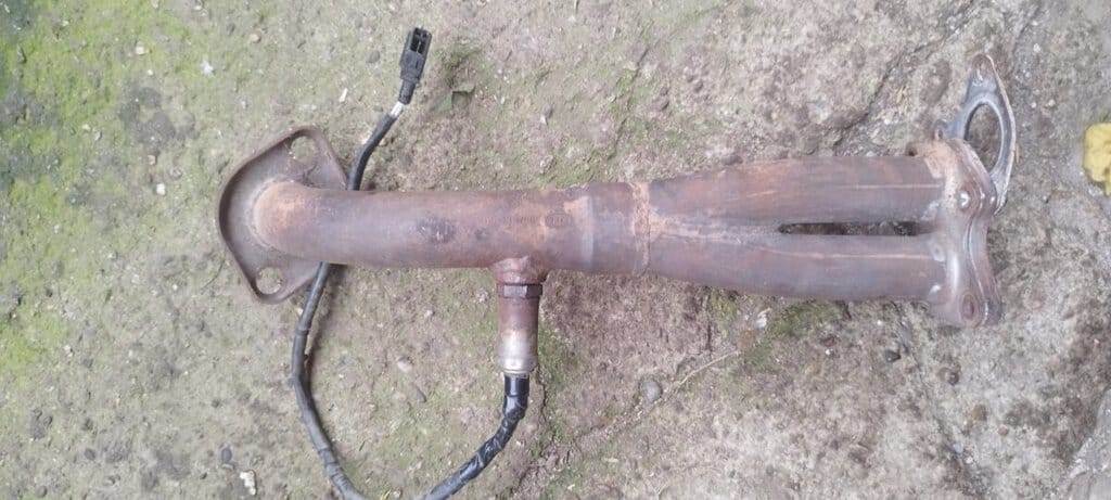 Tlumič odpružení motocyklu s poškozeným těsněním a opotřebovaným kovovým povrchem.